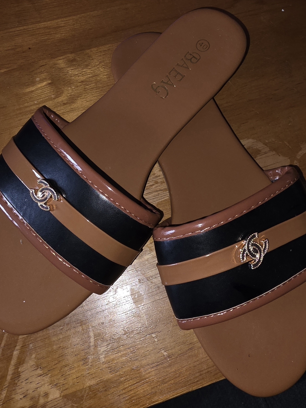 Women’s Tan and Black Slide Sandals with Gold Emblem